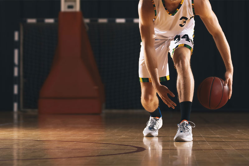 College basketball player dribbling
