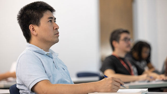 Barney grad listening in class