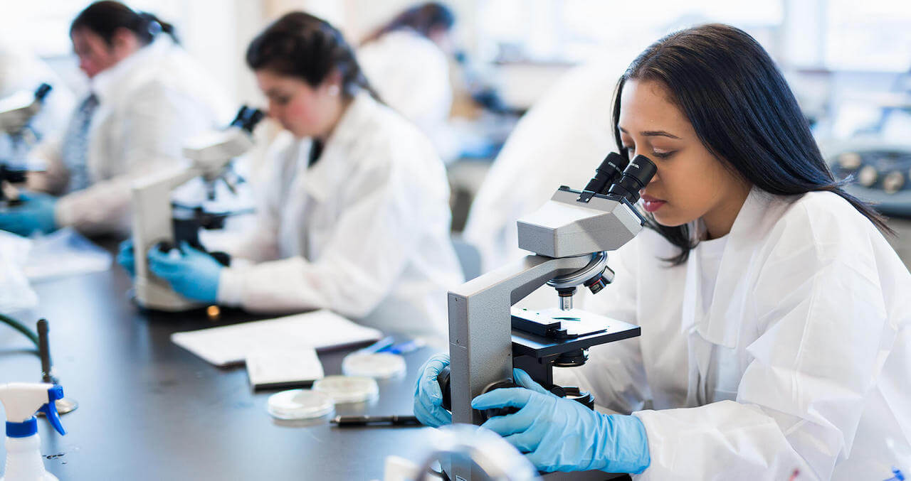 Students with microscopes in a biology lab