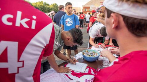 A first-year student signs up for his first club at the Campus Involvement Fair.
