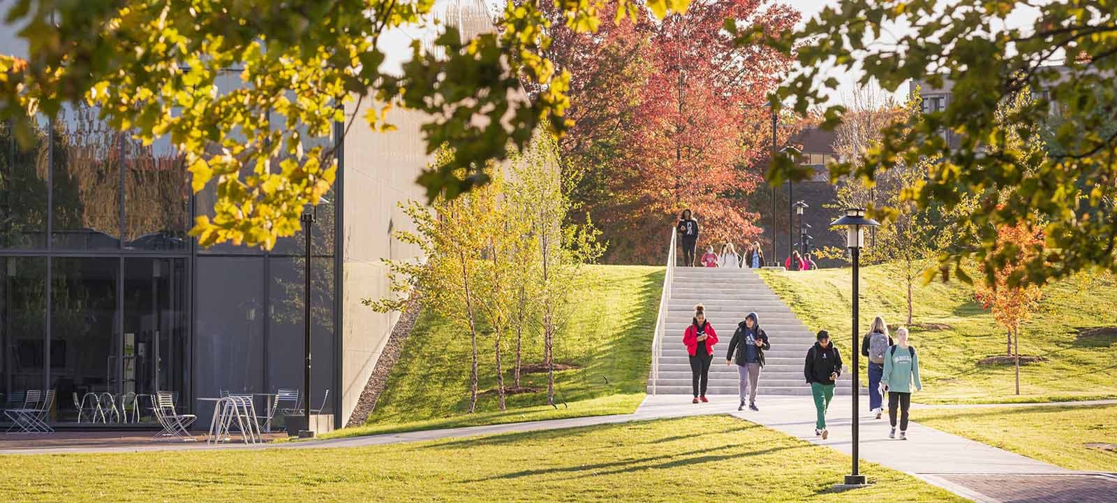 Students walking across the campus green.