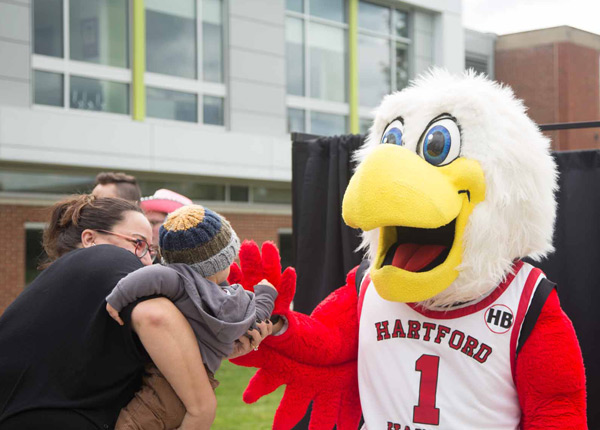 Howie the Hawk mascot greets parents and kids