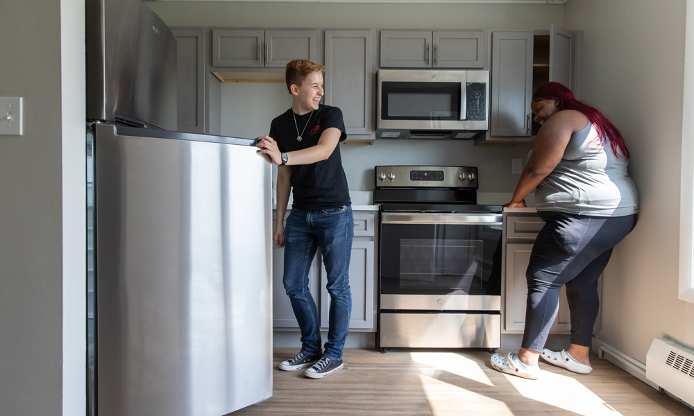 Students standing in remodeled kitchen