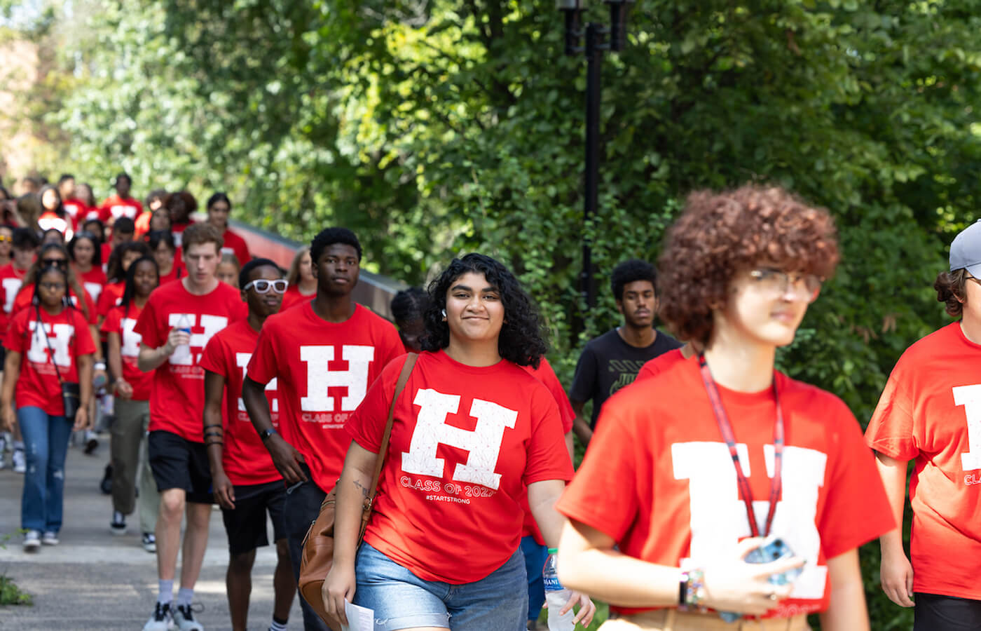 students walking across bridge