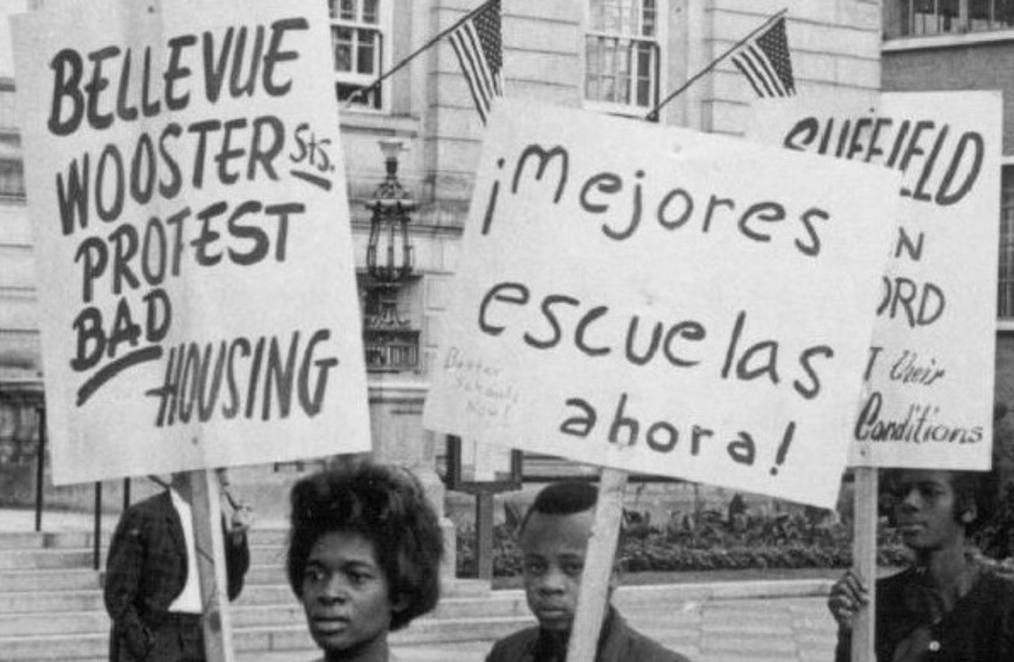 black and white image of people holding signs