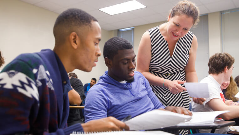 Teacher working with students