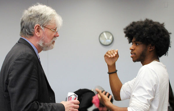 UHart Faculty Member and student engaging in discussion
