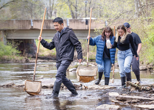 students walking in river