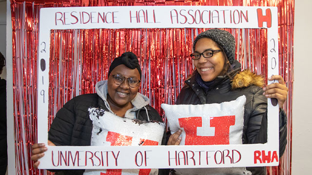 Two UHart students enjoying an event in the residence halls.