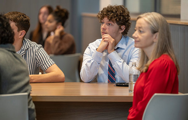 pre-law advising student listening to a speaker