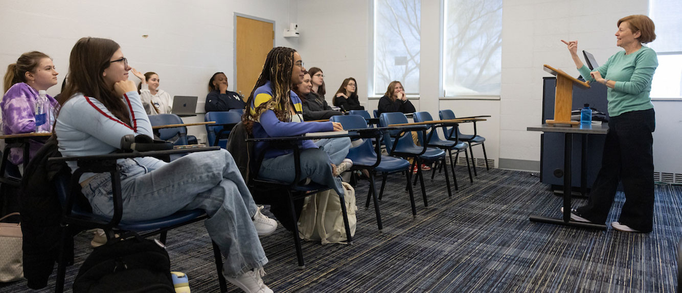 students learning from a professor during a lecture