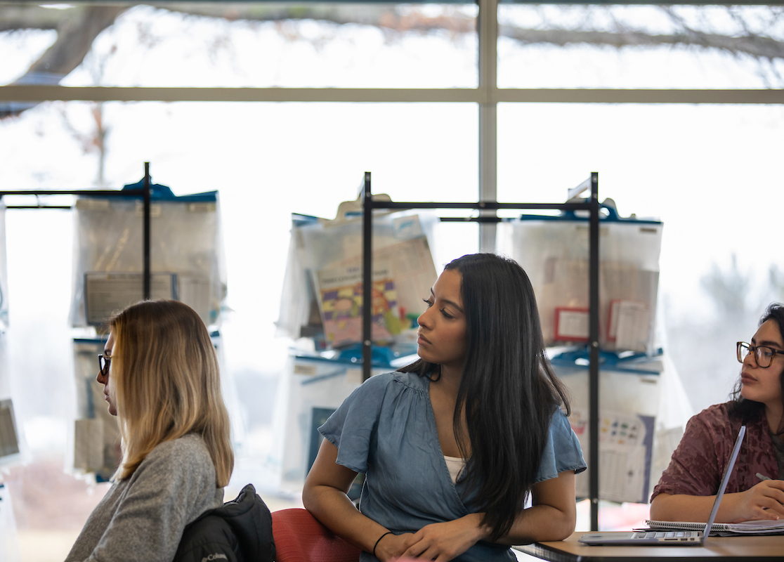 image is of three women learning in a classroom