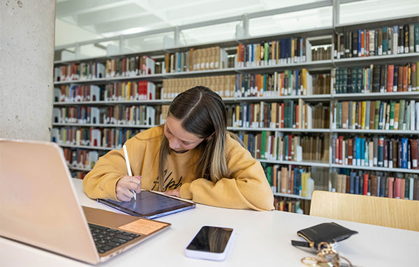 student studying in library