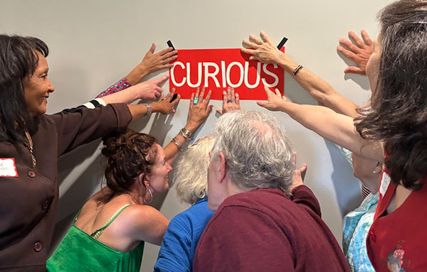PC students with curious sign from Fall Kickoff