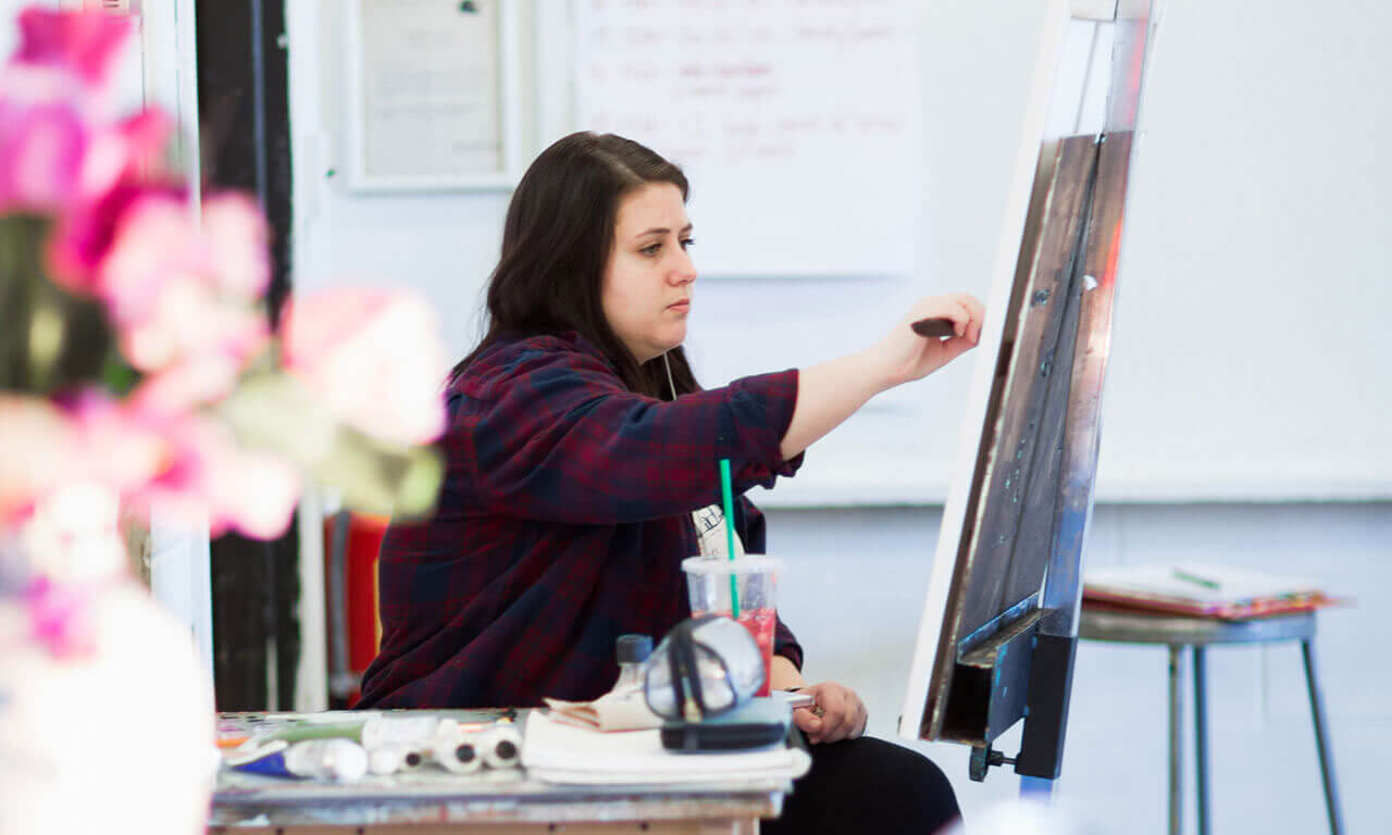 image of student in classroom painting