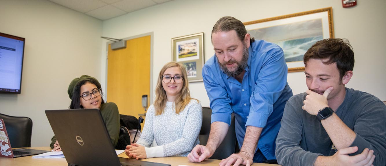 Students Working with Faculty Member.