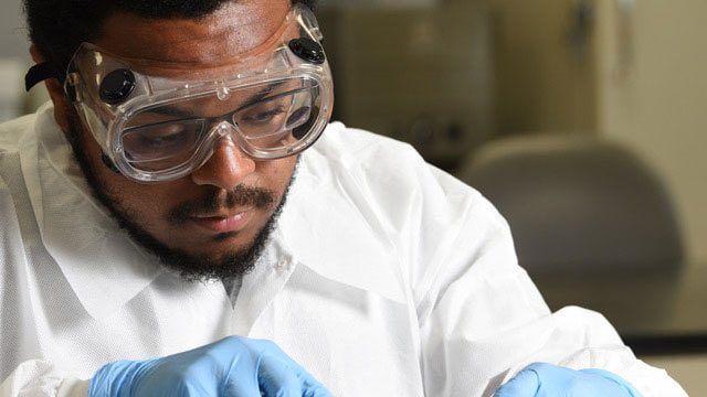 Student performing dissection in lab.