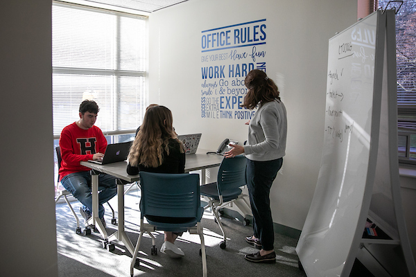inside Crested Communication with students and professor.