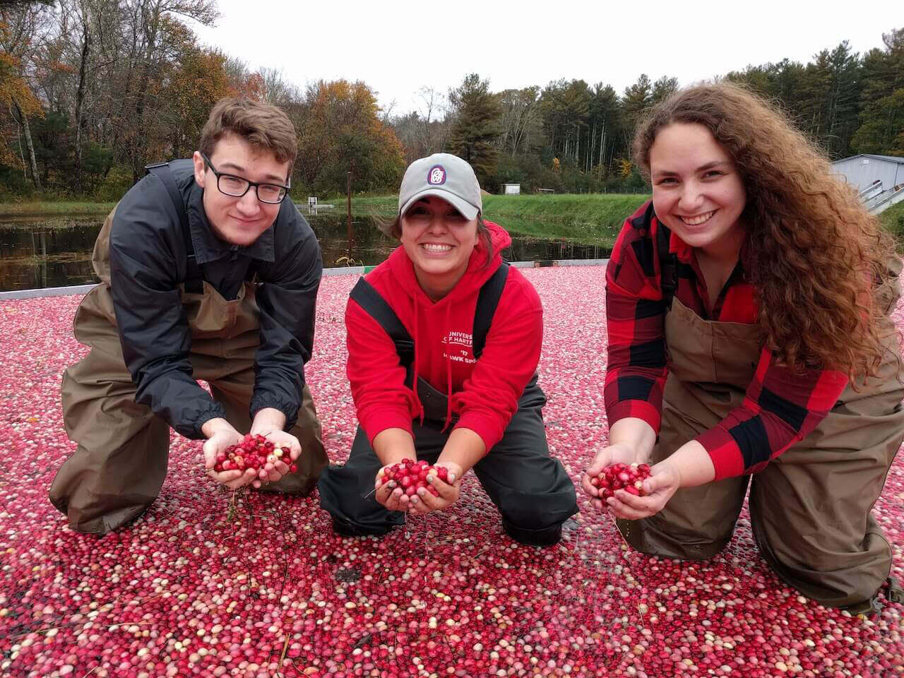 Students holding cranberries 