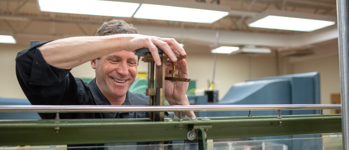 Man looking at device smiling