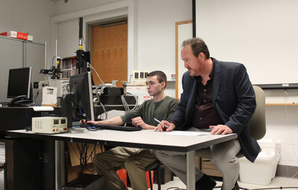 Student and faculty member looking at research