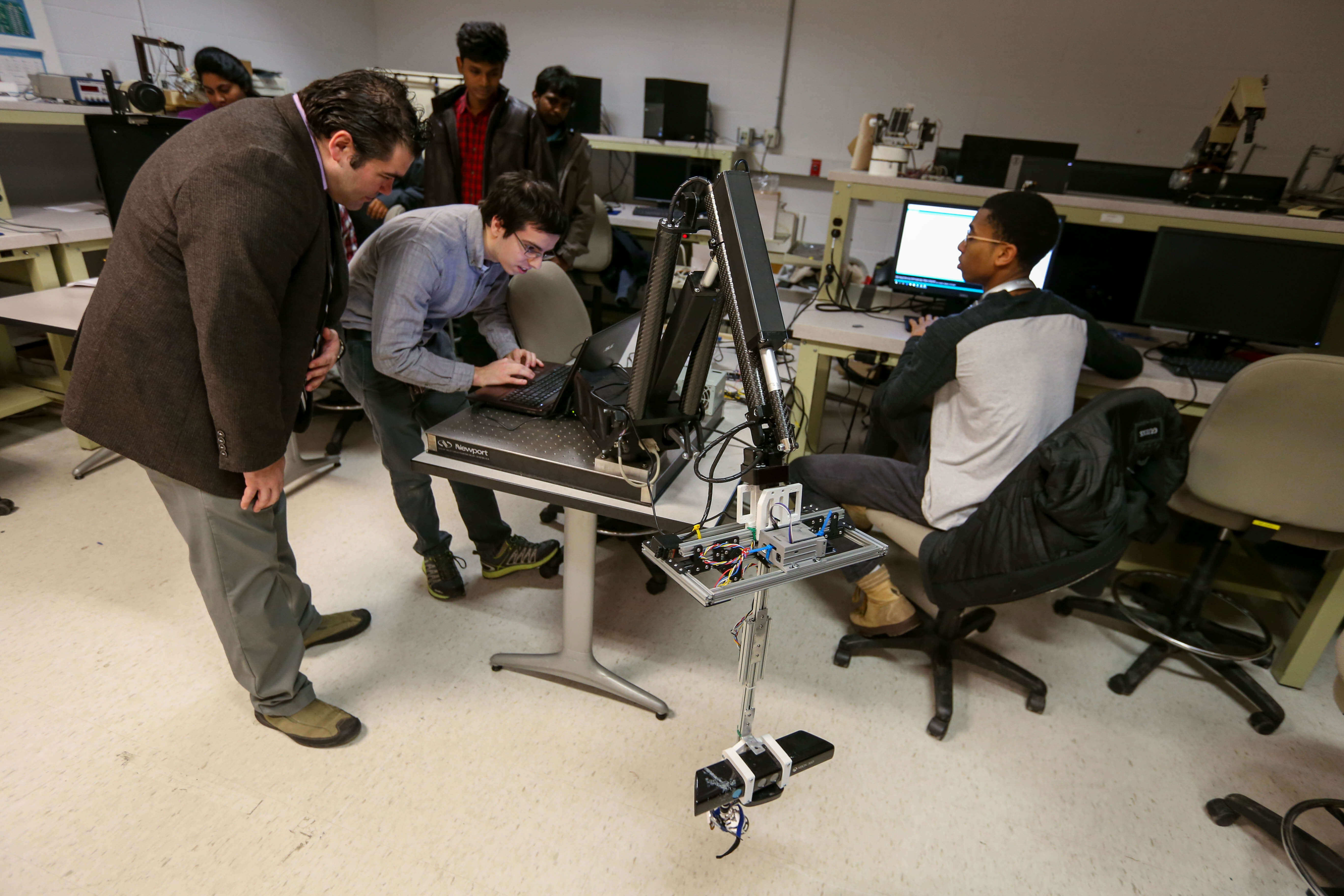 professor and students working on robots