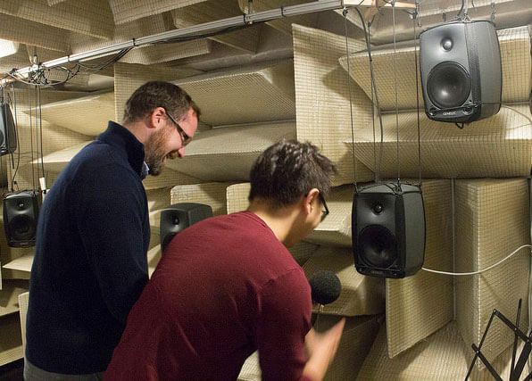 Students studying acoustic equipment