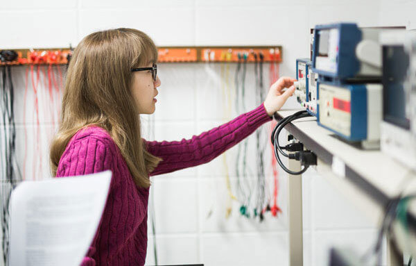 female student working on electrical machine