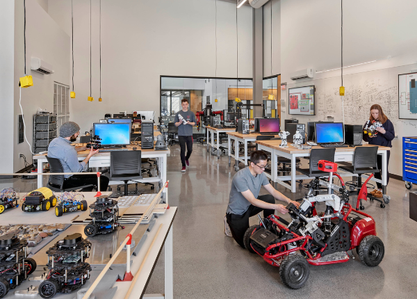 Students collaborating with hands-on robotics project.