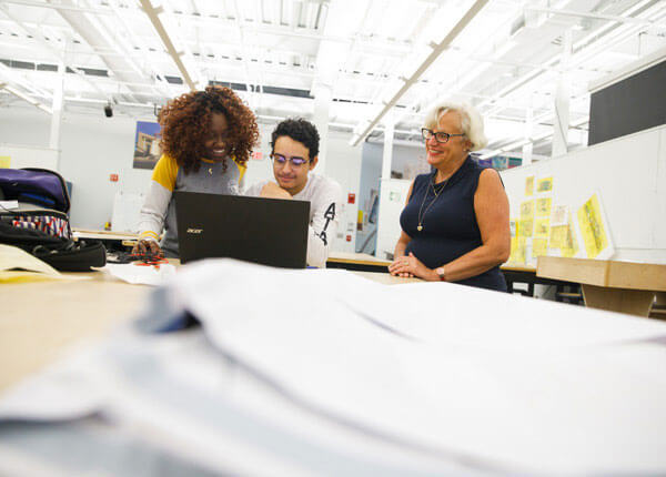 Architecture students working with professor in studio