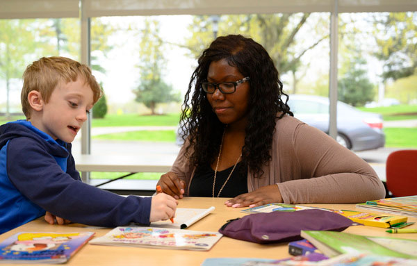 Teacher works with elementary age student