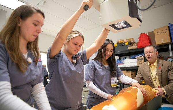 Rad tech professor and students in lab