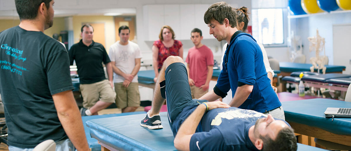 students practicing physical therapy in lab