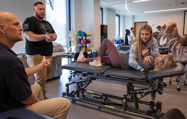 physical therapy students working on table
