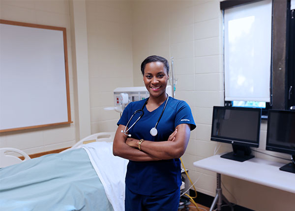 nurse standing in front of hospital bed