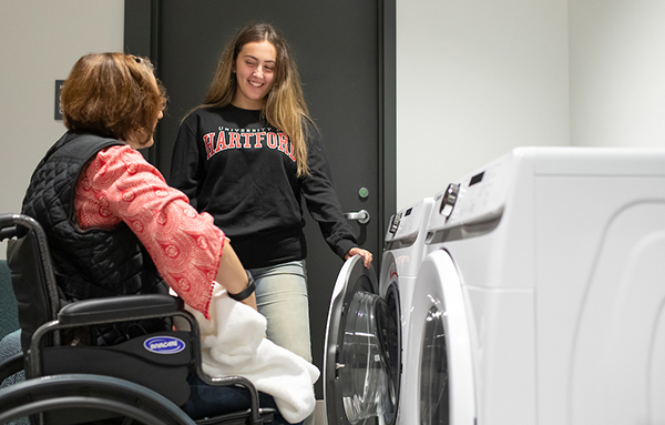 therapist with helping client with laundry