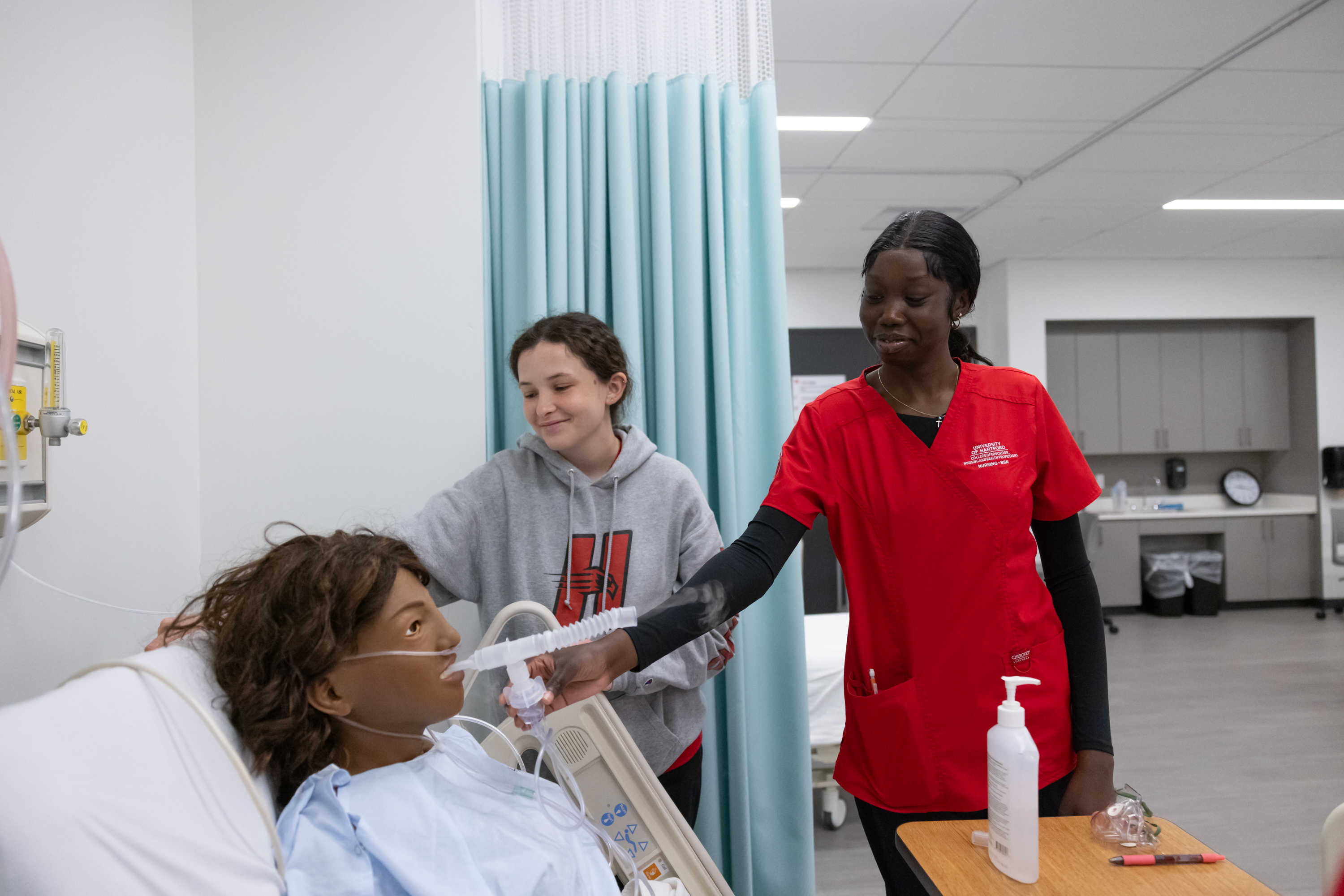 nursing students in simulation lab with manikin