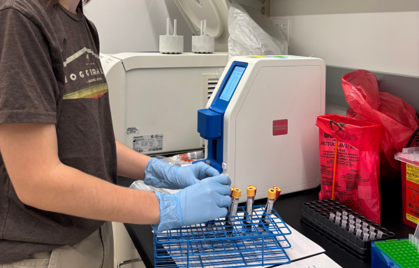 student using lab equipment