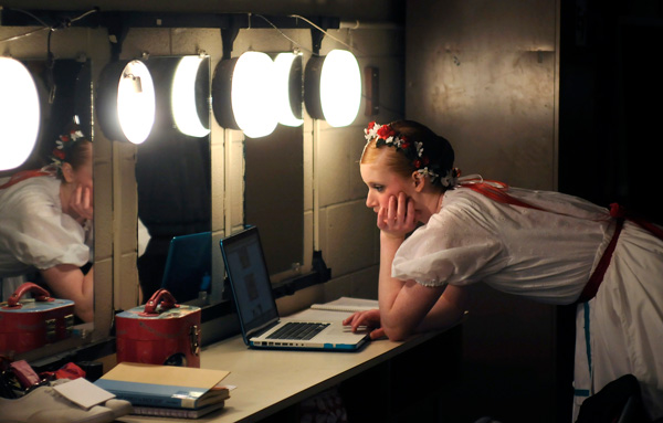 Dance student at computer at rehearsal 