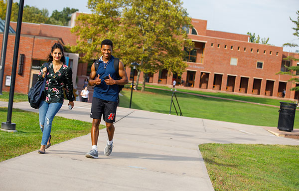 couple walking across campus