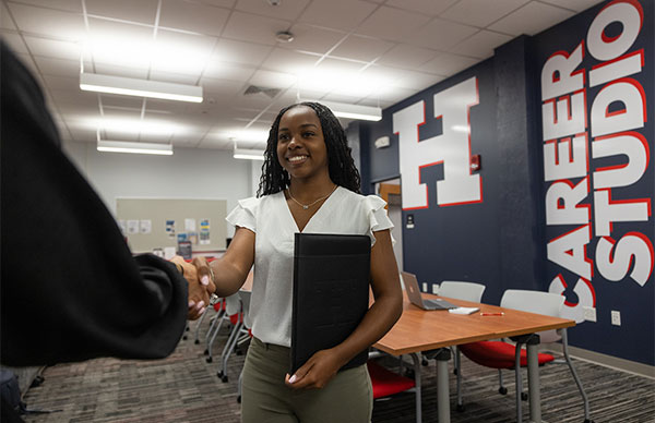 Student mock interviewing for a job