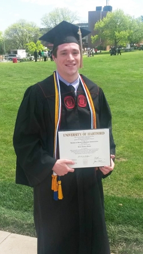 Monks posing with his degree