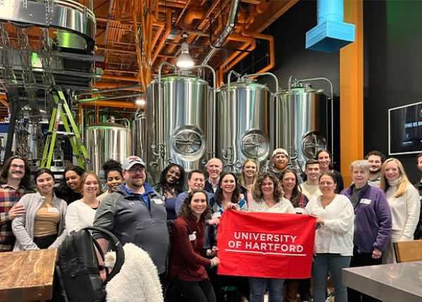 UHart Alumni reunite for fun and group photo at a local brewery.