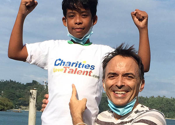 Steve Dunning with child wearing Charity Loves Talent t-shirt