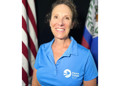 Kim Izzarelli's headshot in front of some flags.