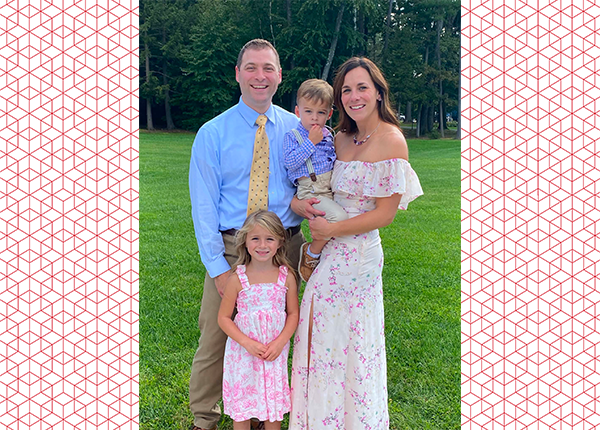 Kevin Cremona posing with his wife and kids