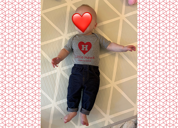 baby in UHart onesie