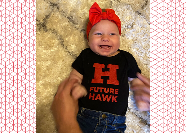 baby wearing a uhart onesie