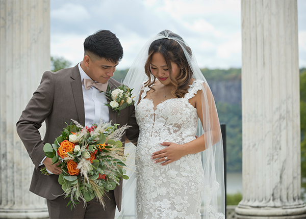 Nicole and her husband posing for a photo at their wedding