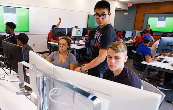 Students discussing in the trading lab